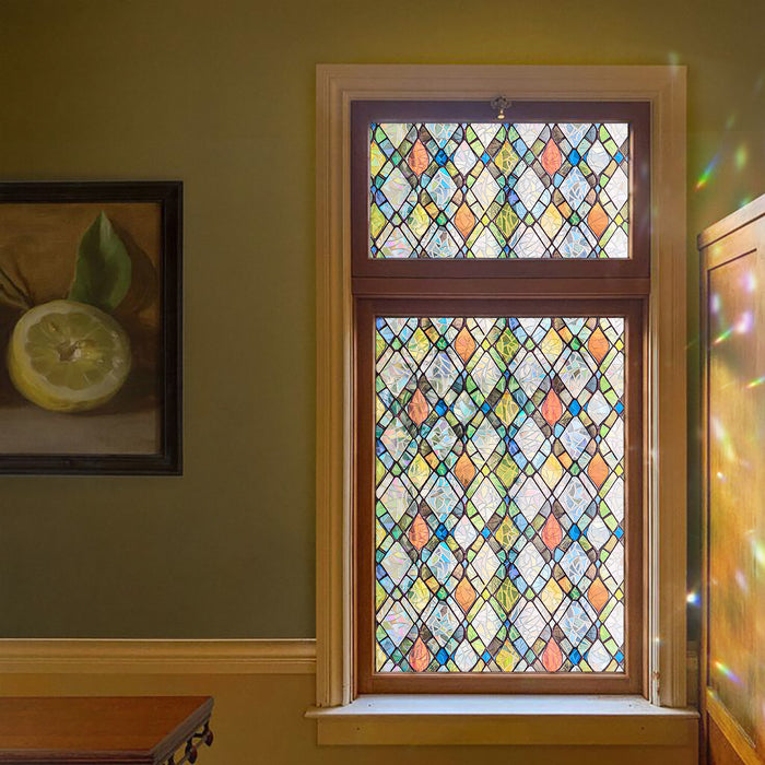 Holographic diamond-lattice window film on a sash window, throwing rainbow light spots onto the wall beside it.