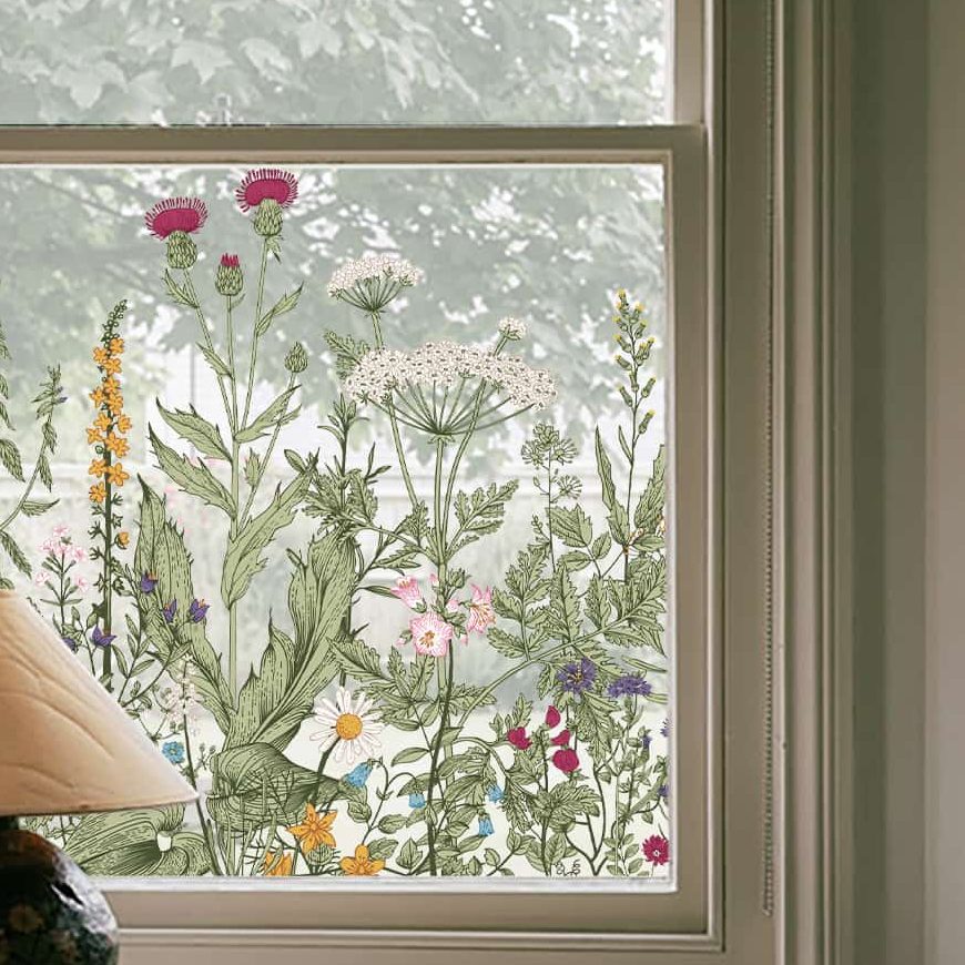 Scenic wildflower window film on a sash window, a painted meadow rising from the sill