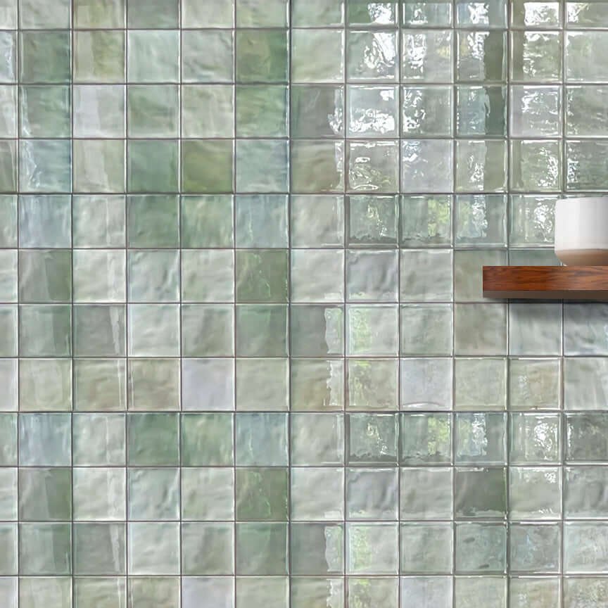 Sage green glazed tile-effect peel-and-stick backsplash covering a kitchen wall