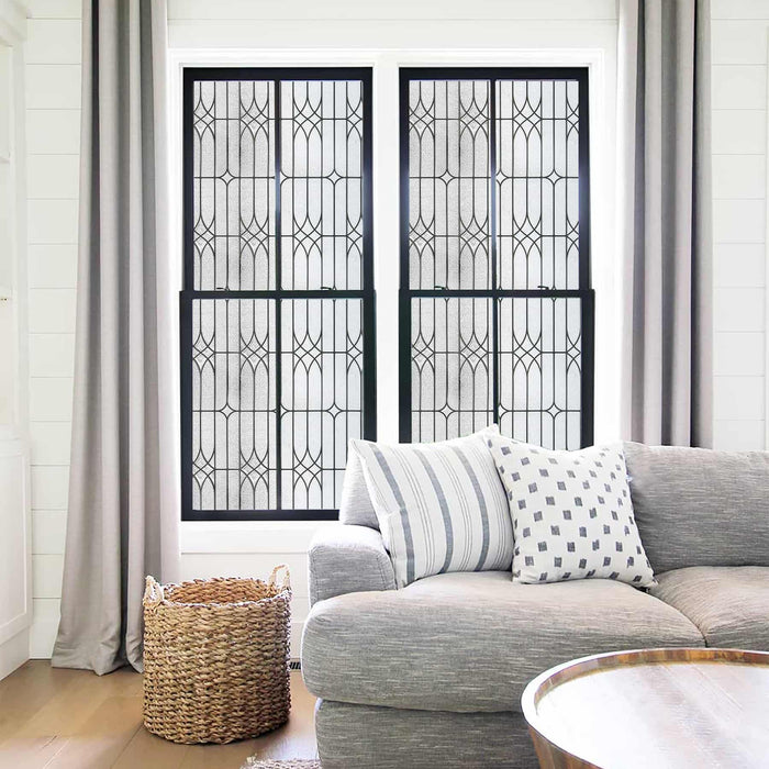 Leaded stained glass window film in a clear diamond came-line grid across a pair of sash windows in a living room